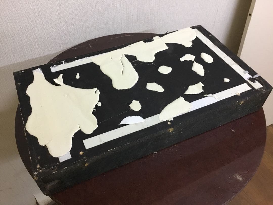 アンティークなテニスラケットの歴史と変遷について解説している彫刻が収められた額装